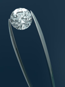 A diamond in a pair of tweezers. 3D render with HDRI lighting and raytraced textures.